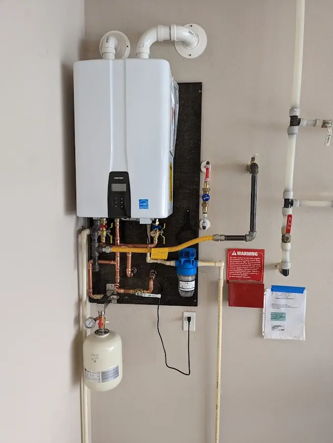 Professional plumber installing copper piping in a Salida home